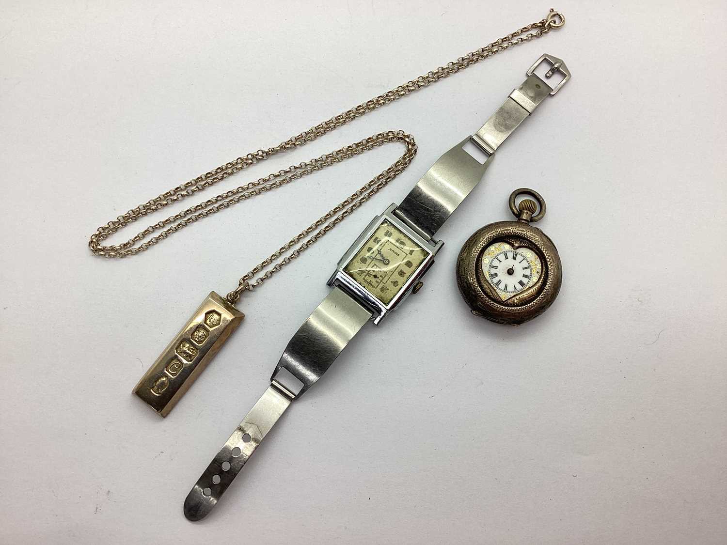 A Decorative Fob Watch, with heart shape dial (lacking glass and hands), within allover engraved