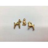 Two 9ct Gold Poodle Charm Pendants, together with a cat charm stamped "9ct". (3)