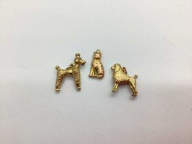 Two 9ct Gold Poodle Charm Pendants, together with a cat charm stamped "9ct". (3)