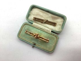 A Seed Pearl Set Bar Brooch, together with another bar brooch stamped "9ct". (2)