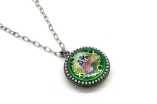 A Decorative Pearl Set Circular Locket Pendant, glazed front and hand painted verso within green