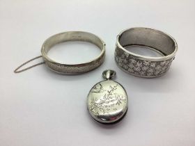 A Victorian Aesthetic Oval Locket Pendant, together with a vintage wide hinged bangle and a