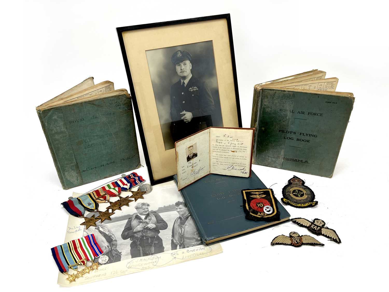 WWII RAF Fighter Command Air Crew Europe Star Medal and Log Book Grouping, plus cloth insignia,