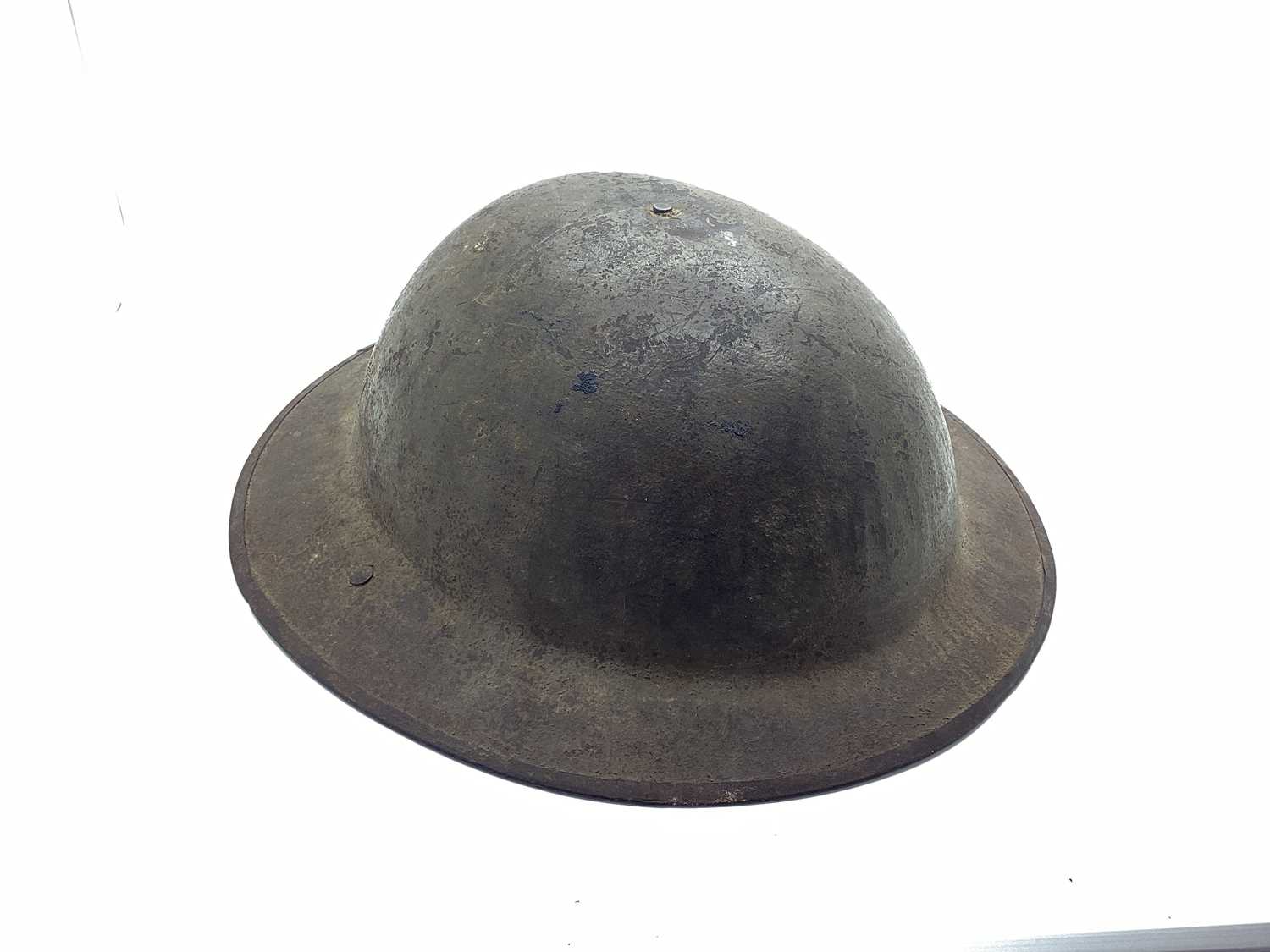 WWI British Army Brodie Mk I steel helmet with part liner and leather strap, marks on the interior