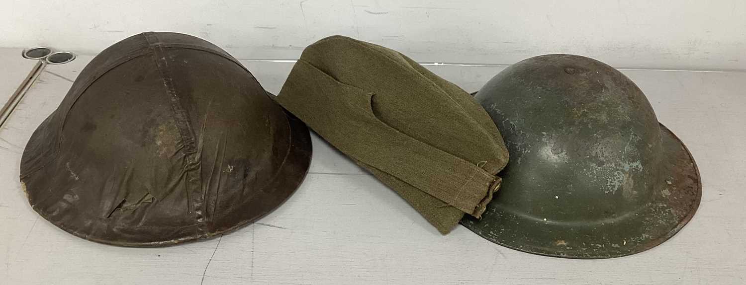 WWII British Brodie Helmets, comprising helmet with cover, liner and chinstrap and helmet with