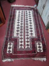 Middle Eastern Tassled Wool Rug, with allover geometric motifs to cream bottle shaped ground