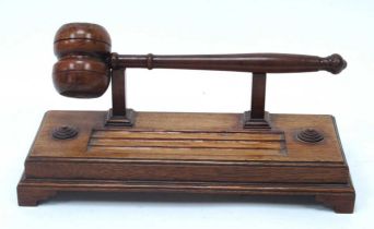 A Late XIX Century Mahogany Gavel, on a footed rectangular stand with three pen rests, 11 x 31cm.