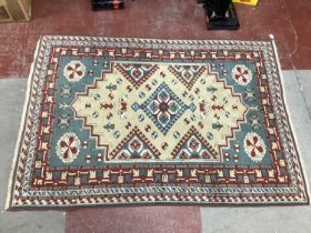 A Persian Style Wool Rug, the centre with lozenge decoration, 145 x 202cm.