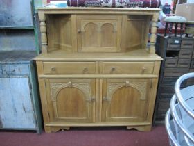 Light Oak Court Cupboard, top with a single cupboard door, with arched decoration, over two small