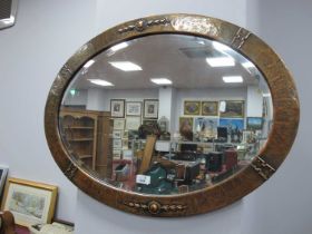Oval Bevelled Wall Mirror, in beaten copper frame with strapwork, 76cm, wide.