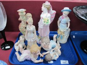 Four Piano Babies (one damaged). four continental bisque figurines, the tallest 23cm:- One Tray