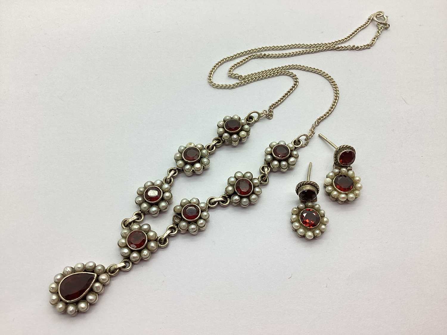An Ornate Stone Set Necklace and Earring Set, the flowerhead design throughout, to pear shape
