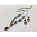 An Ornate Stone Set Necklace and Earring Set, the flowerhead design throughout, to pear shape