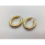 A Pair of Modern Unoaerre 9ct Gold Chunky Hollow Oval Hoop Earrings, (4.6grams).