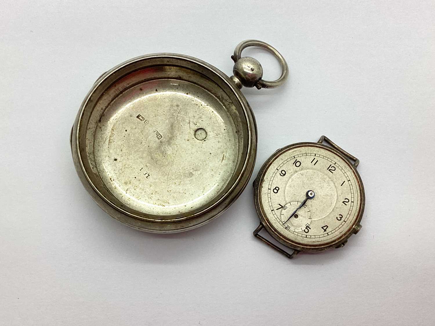 A Hallmarked Silver Watch Head, the unsigned white dial, with seconds subsidiary dial (hands