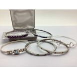 The Genuine Gemstone Company; "925" Zambian Amethyst Set Hinged Bangle, the round cut stones to four