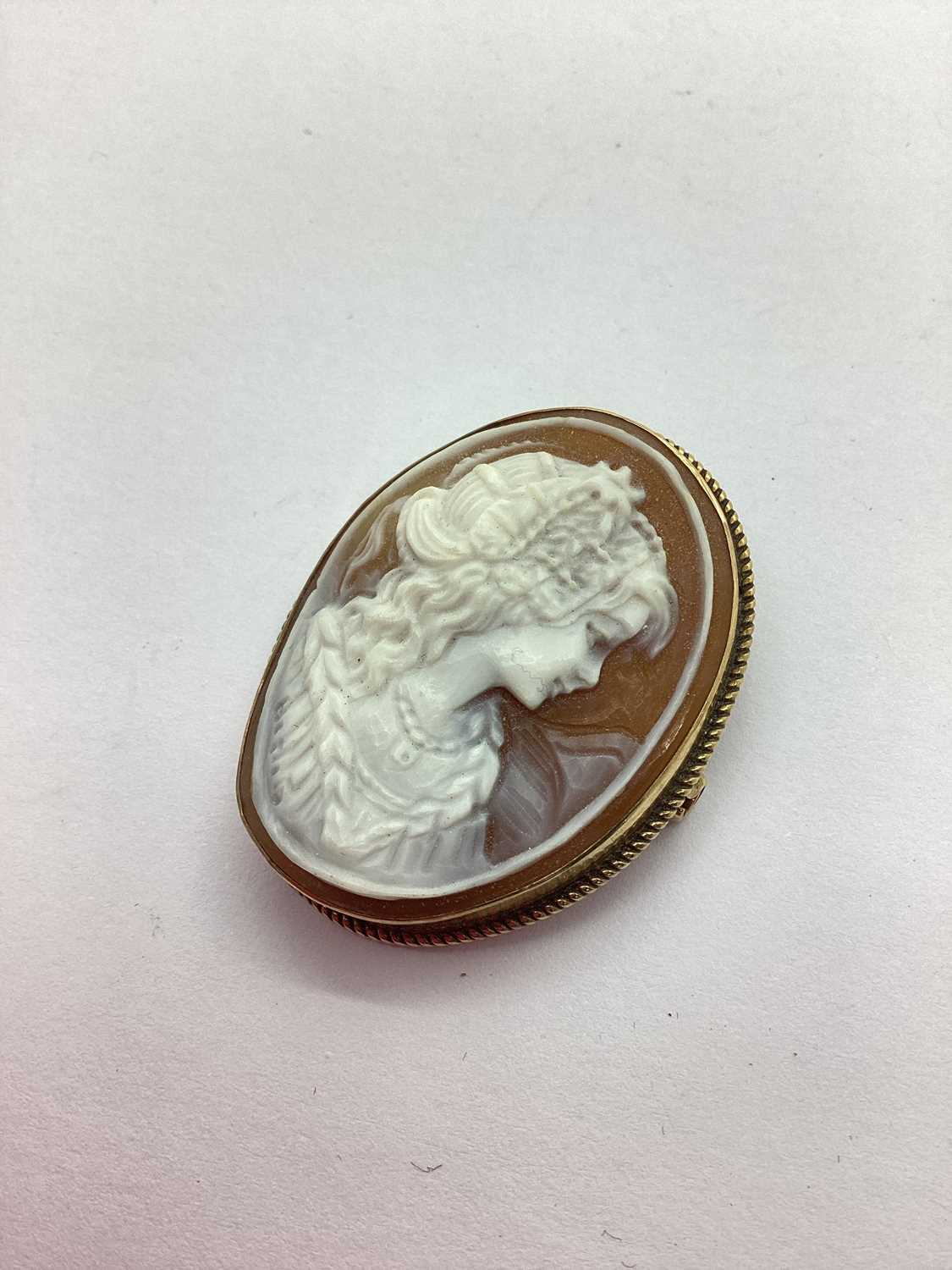 A Hallmarked 9ct Shell Cameo Brooch, the ornately carved portrait of a lady, set within twisted