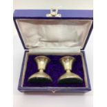 A Pair of Dwarf Candlesticks (bases weighted), stamped "SILVER", 7.5cm height, in a blue fitted box