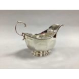 A Hallmarked Silver Sauce Boat, Adie Bros, Birmingham 1930, of panelled design with leaf capped