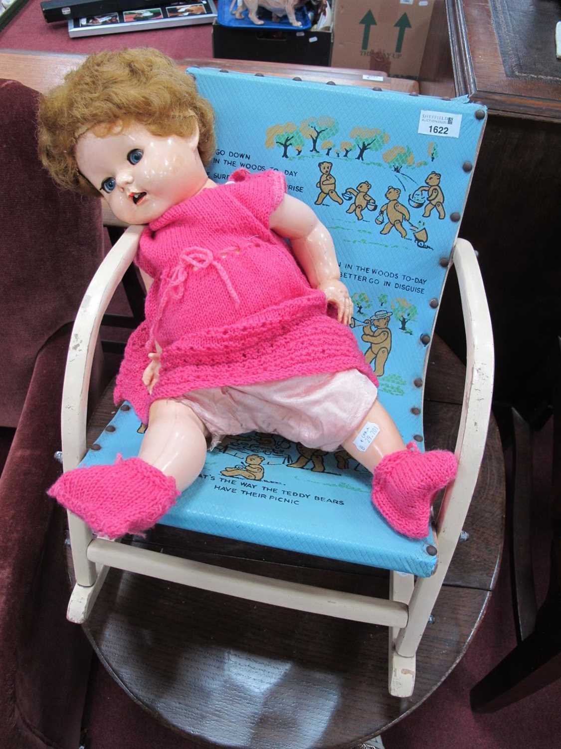 A Circa 1930's Child's Rocking Chair, the cover and seat inscribed with picture;s and word from 'The