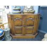 Oak Corner Cupboard, with a glass top, twin panelled doors, on a plinth base.