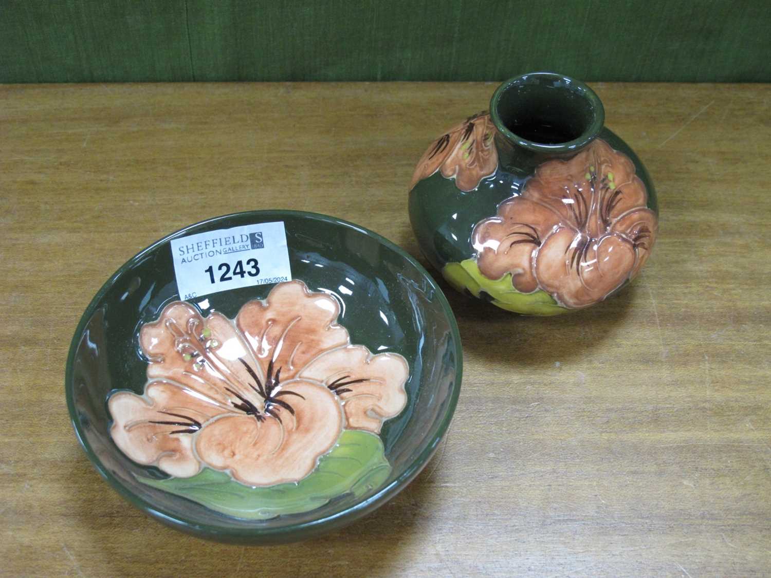 Moorcroft Shallow Circular Bowl, decorated in the Hibiscus Pattern in peach on a green ground,