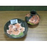 Moorcroft Shallow Circular Bowl, decorated in the Hibiscus Pattern in peach on a green ground,