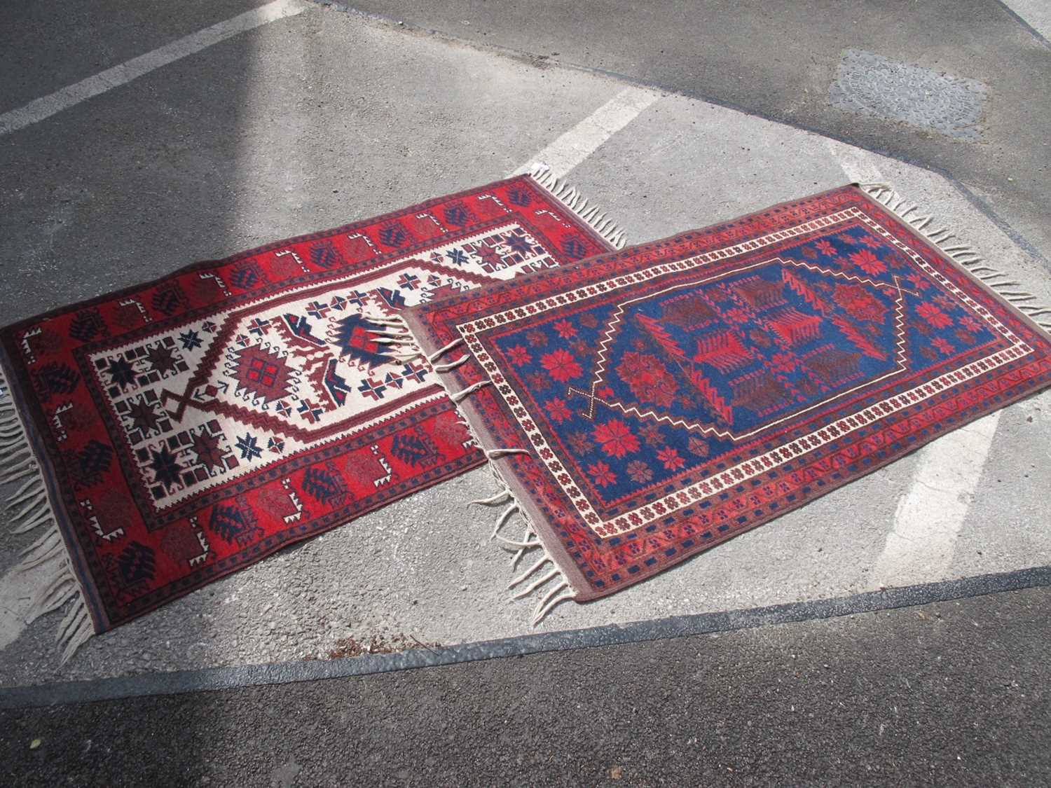 Middle Eastern Wool Tassled Rug, with allover geometric motifs on cream ground within red border 134