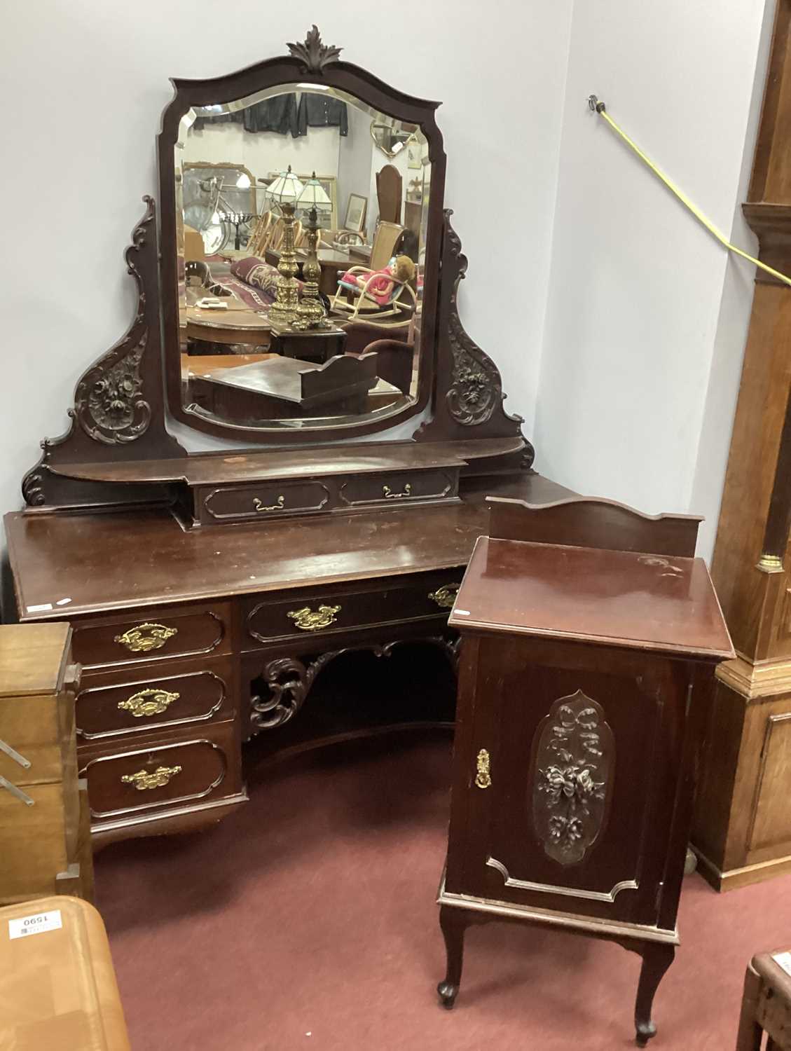 An Early XX Century Mahogany Dressing Table, with central mirror, shaped mirror supports with 'C'