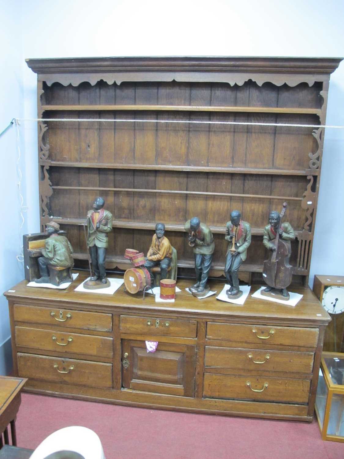 A Late XVIII/Early XIX Century Oak Dresser, the rack with a moulded pediment and three shelves,