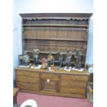 A Late XVIII/Early XIX Century Oak Dresser, the rack with a moulded pediment and three shelves,