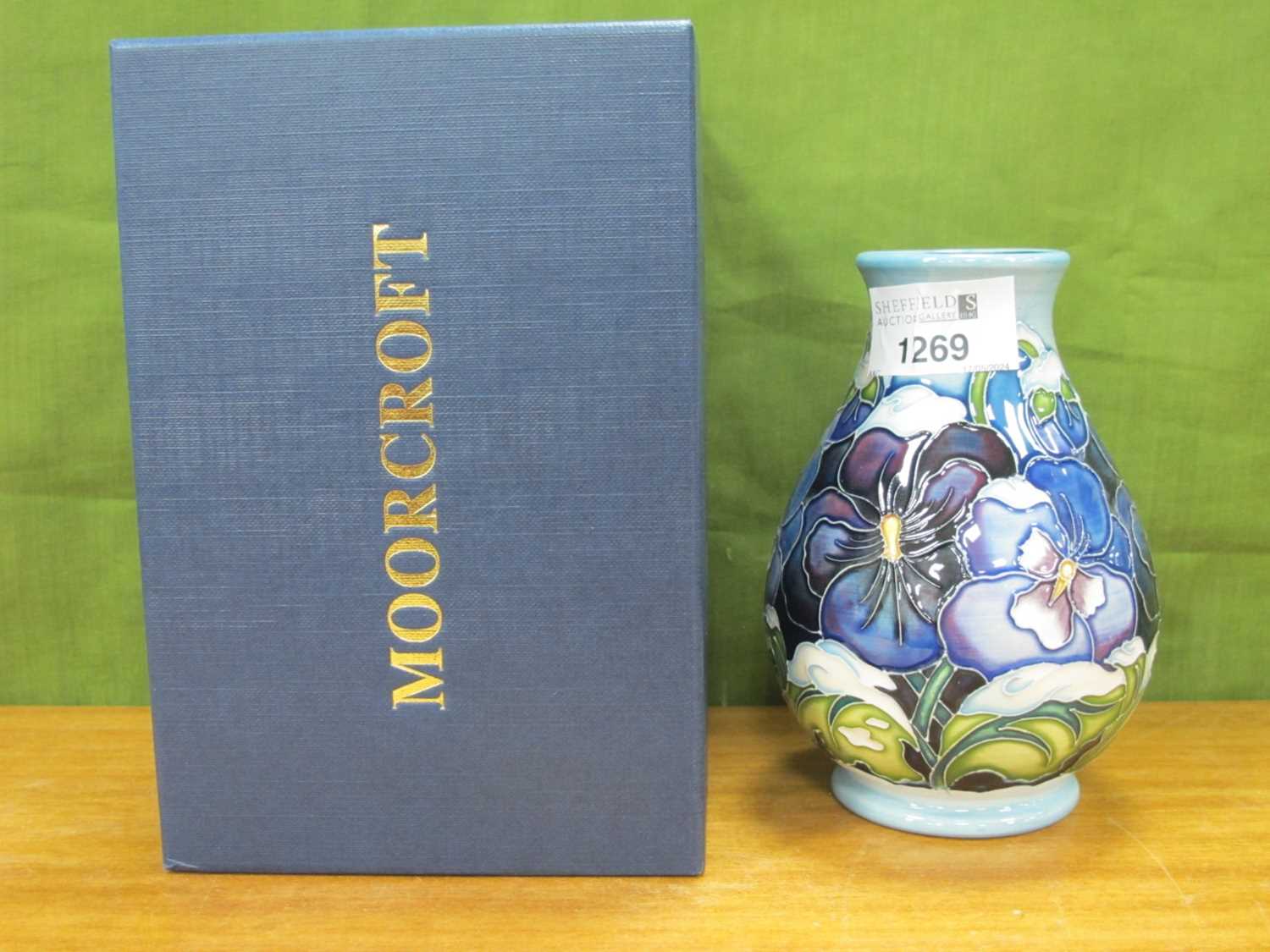 A Moorcroft Pottery 'Christmas Pansy' Design Baluster Vase, impressed and painted marks, signed R.