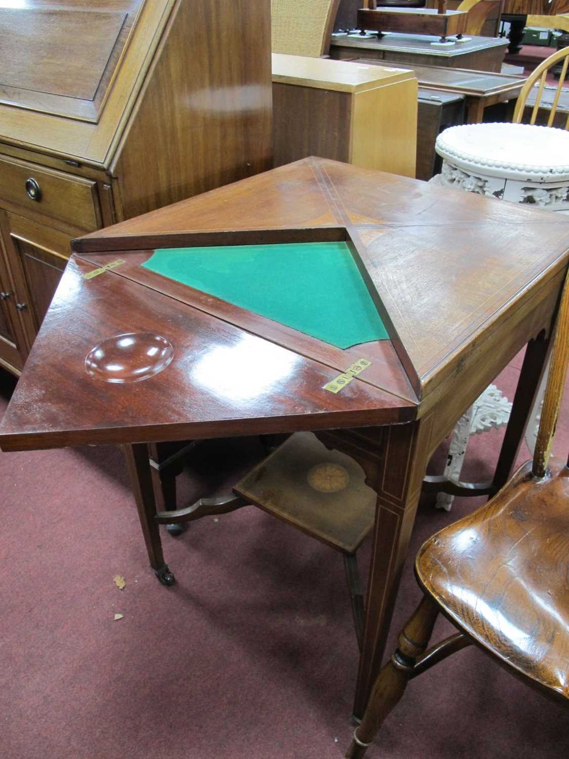 An Edwardian Mahogany Inlaid Envelope Table, with swivel top, green baized interior with guinea