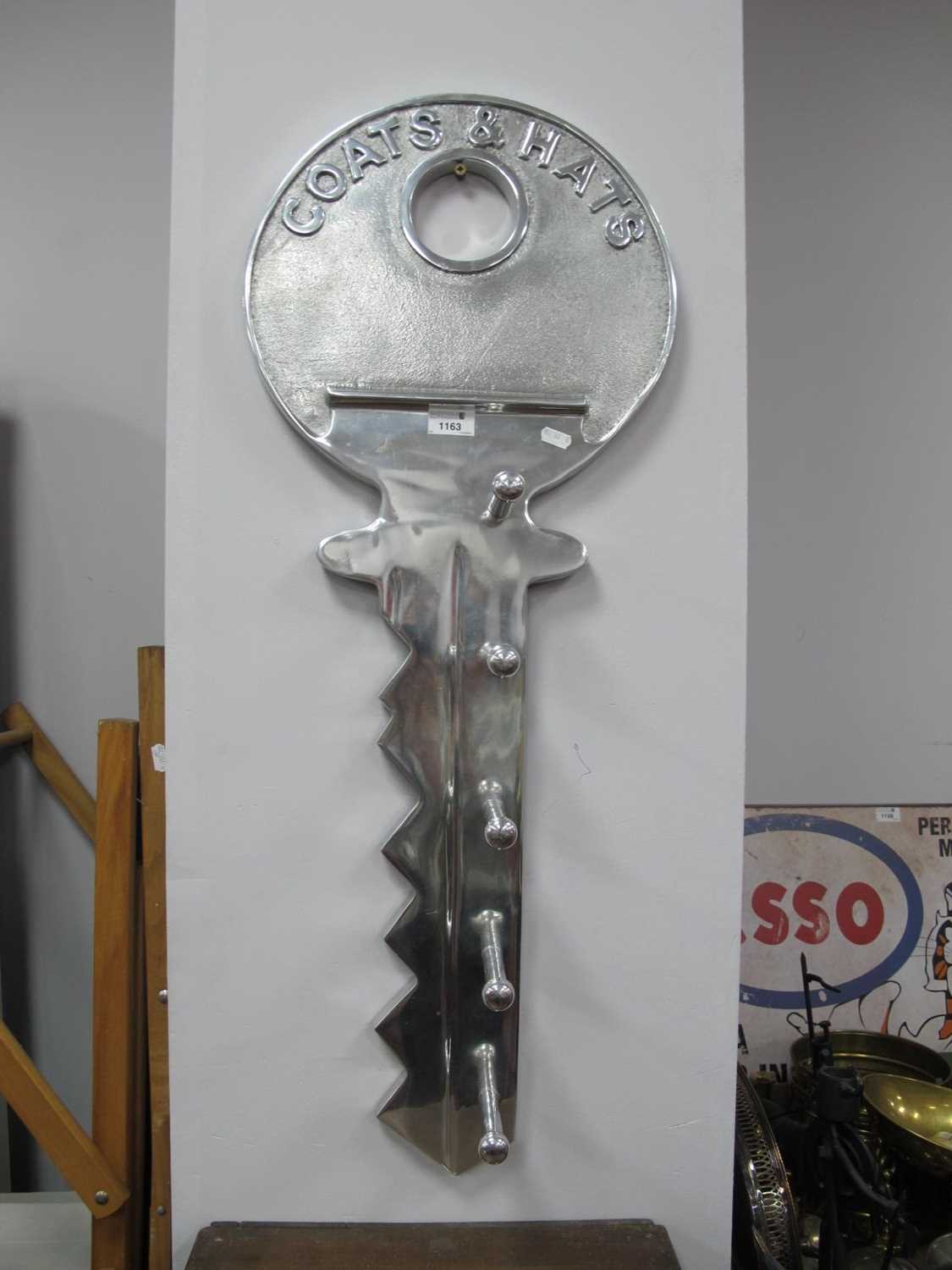 A Contemporary Aluminum Coat Rack, designed as a large vintage latch key with motif "Coats and