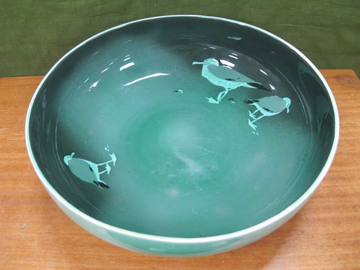 A Royal Doulton Bowl, with green interior, decorated with birds, Regd No 374874, 37cm diameter.