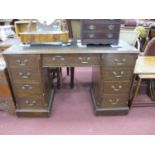 An Early XX Century Oak Pedestal Desk, with crossbanded top, brown leather insert over central
