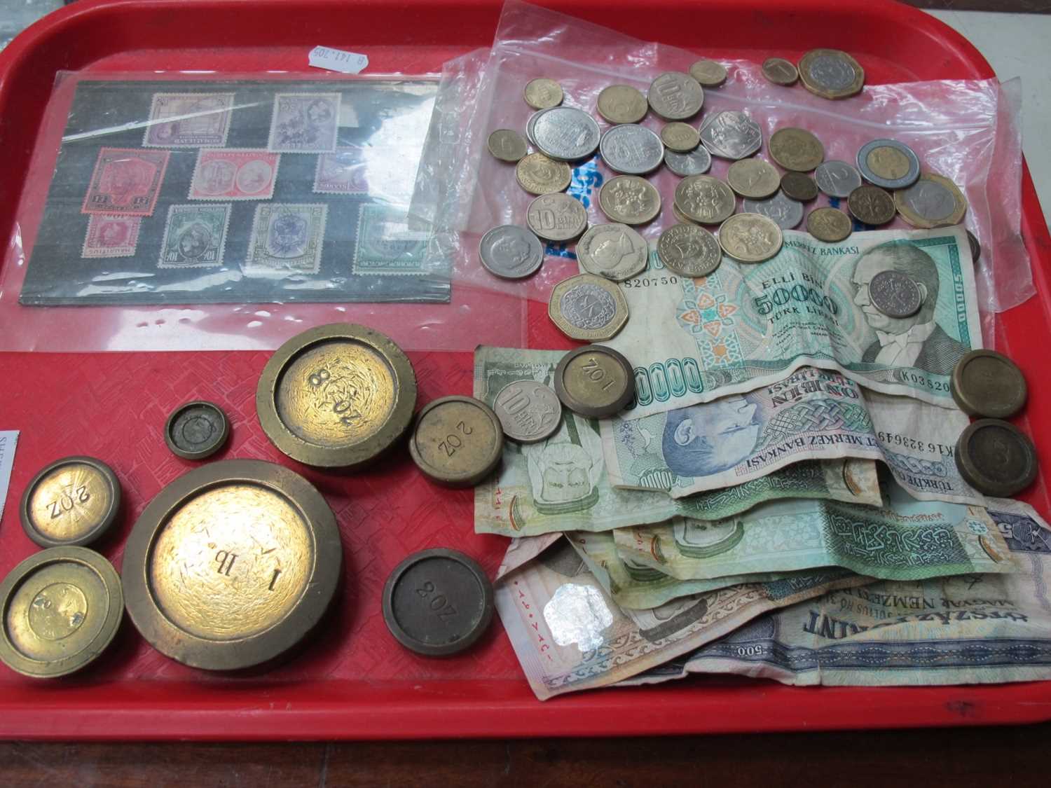 Foreign Currency, banknotes mainly Middle Eastern, brass weights, postage stamps:- One Tray