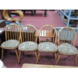 Ercol, Set of Four Light Wood Low Hoop top chairs, with spindle backs on splayed legs.