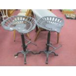 Pair of Cast Iron Tractor Seat Bar Stools, with foot rests.