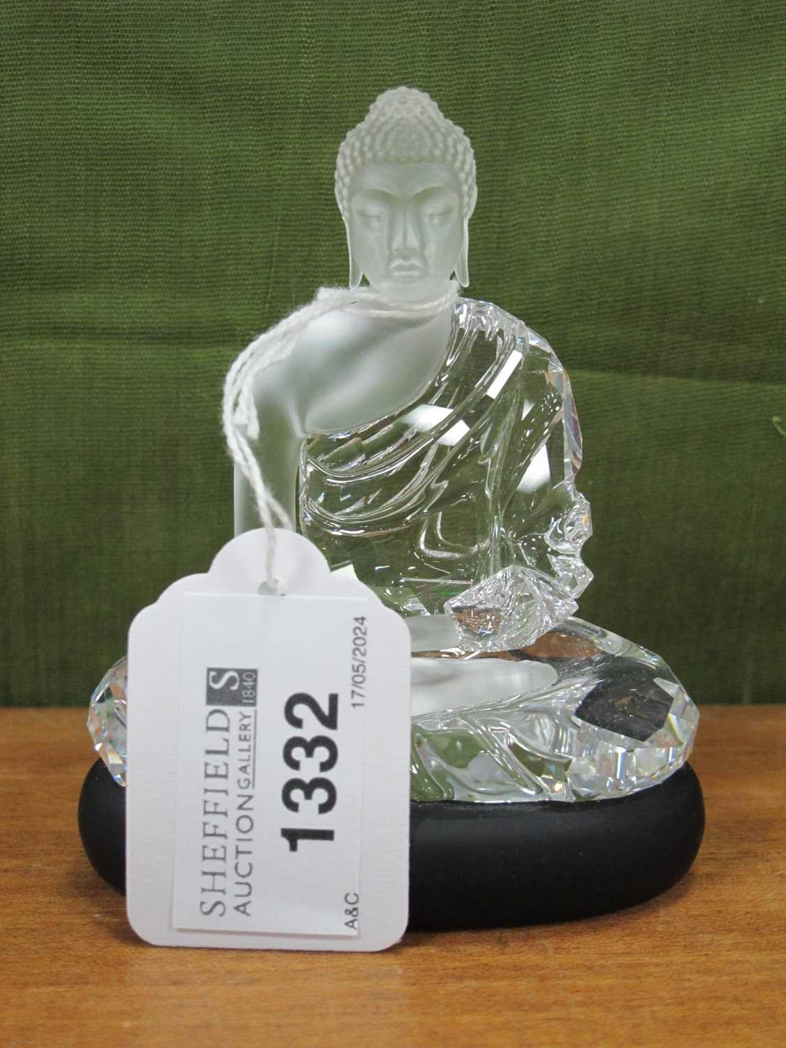 A Swarovski Crystal Model of the Guatama Buddha, sitting on a matt black crystal base, designed by