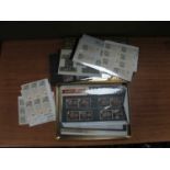 Stamps; A biscuit tin containing Great Britain presentation packs, booklets and stamps with a face