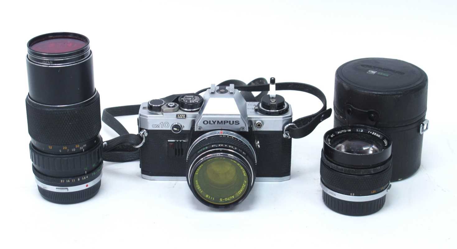 Olympus OM10 camera together with three Olympus Zuiko OM lenses comprising of MC Auto-W 35mm F2 wide