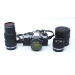 Olympus OM10 camera together with three Olympus Zuiko OM lenses comprising of MC Auto-W 35mm F2 wide