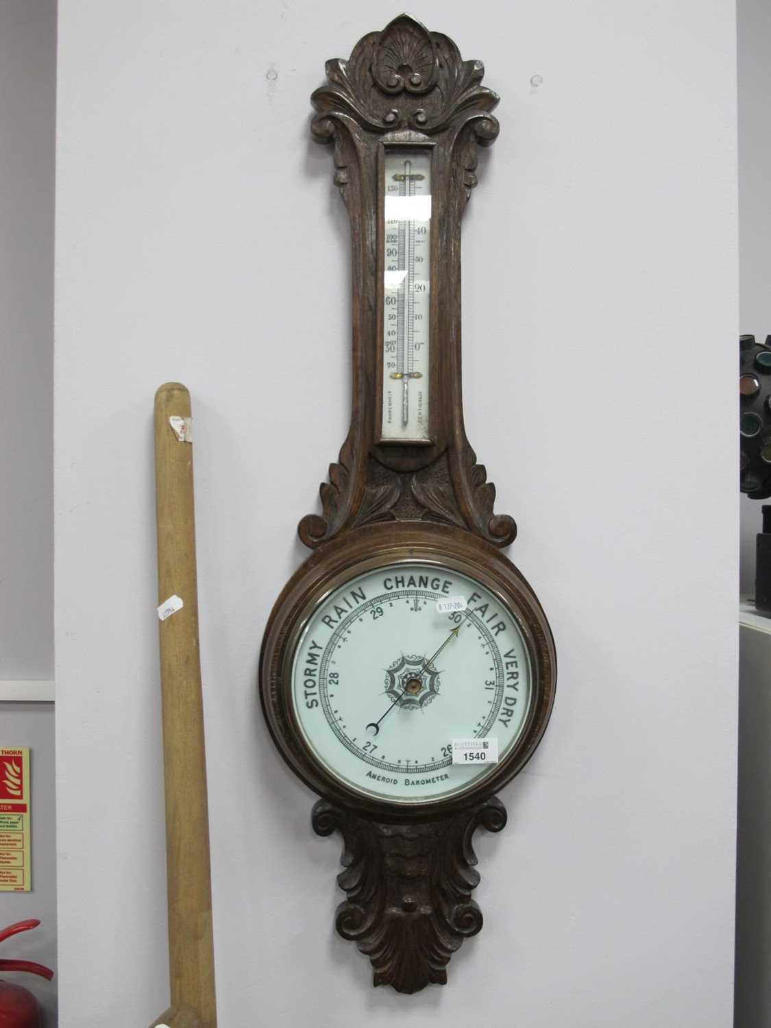 Early XX Century Carved Oak Two Dial Aneroid Barometer, 86cm high.