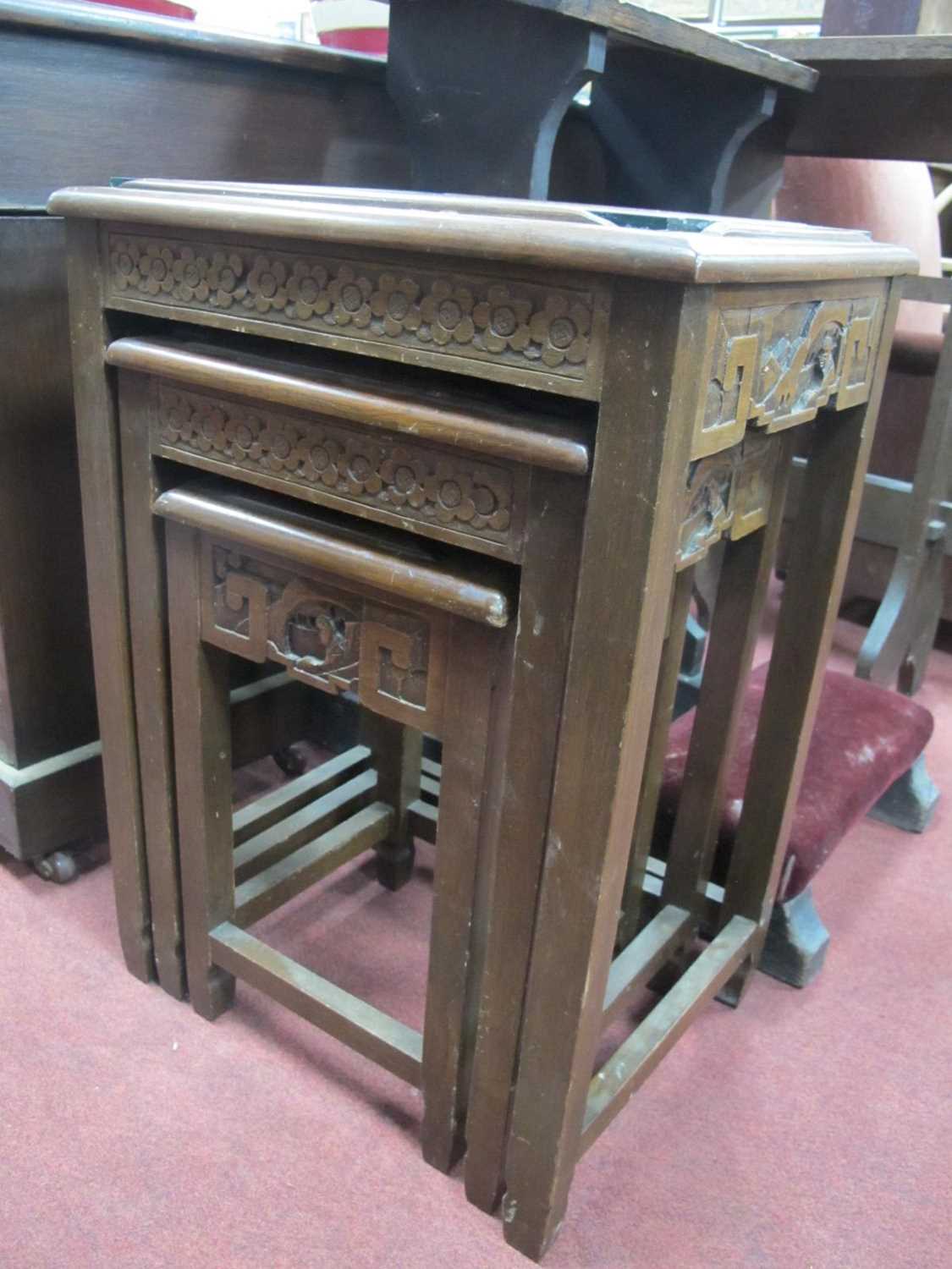 Oriental; A Nest of Tables, the tops with carved decoration, on square supports.