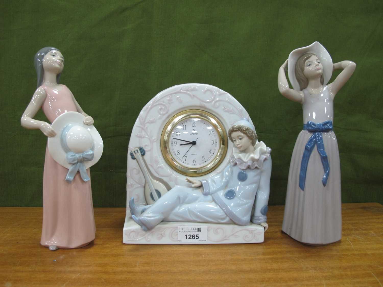 Lladro Porcelain Clock, with reclining clown and lute, 21cm high, together with two Lladro figures
