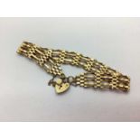 A 9ct Gold Gate Link Bracelet, to heart-shape padlock style clasp with safety chain (6grams).