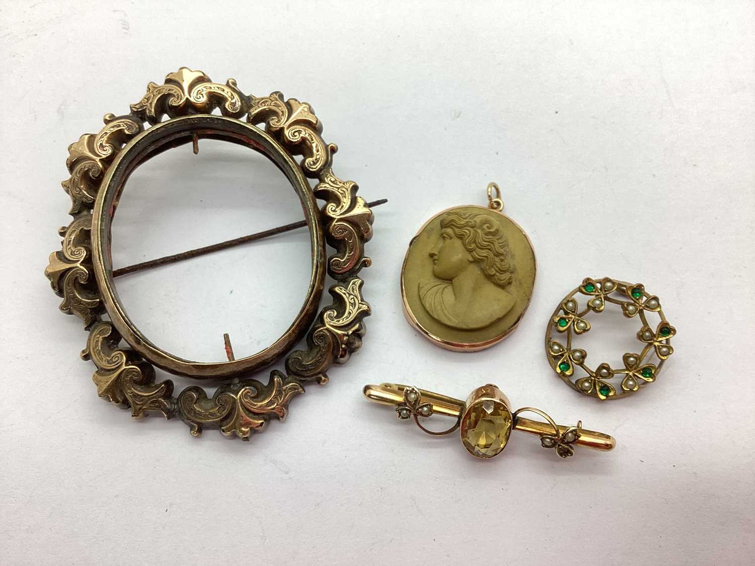 A Large Victorian Swivel Brooch, (lacking centre); a lava cameo pendant 'Apollo'; a vintage