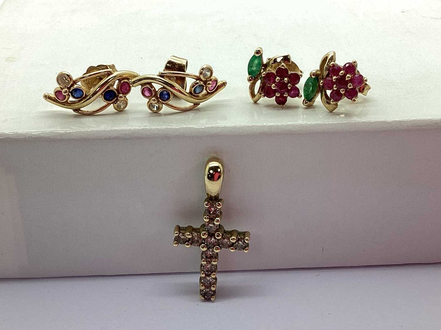 A Diamond Set Cross Pendant, stamped "375", together with a pair of ruby and emerald set earrings,
