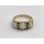 A Victorian Style Three Stone Ring, the oval stones alternately set, between reeded claw setting,